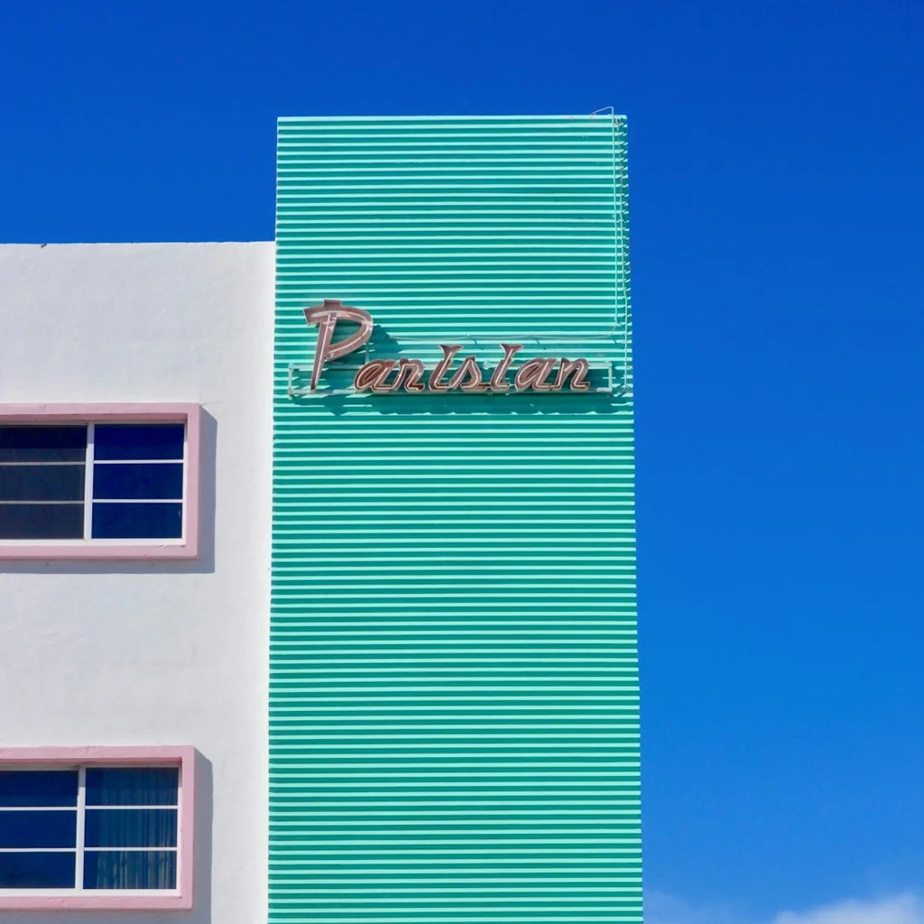 white and teal concrete building under blue sky during daytime - passive income