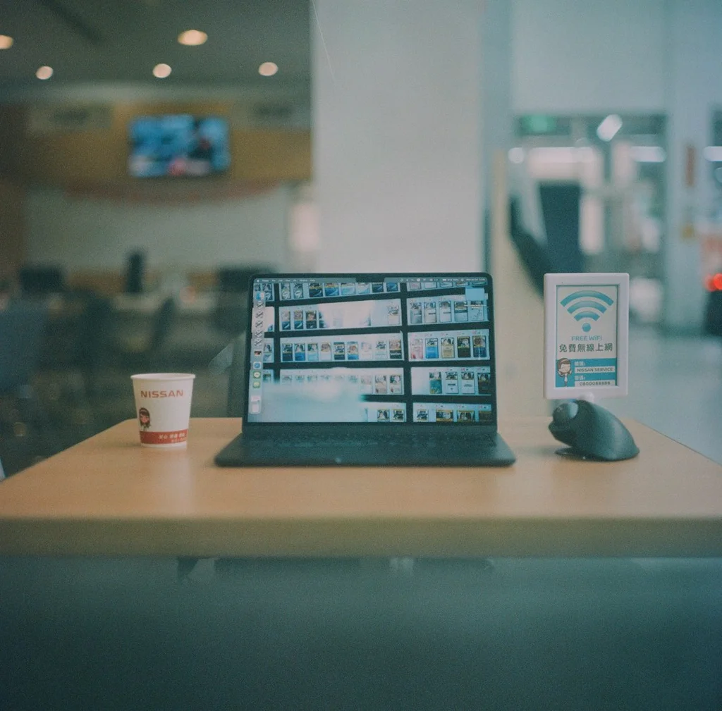 a laptop computer sitting on top of a wooden table - freelance platforms comparison