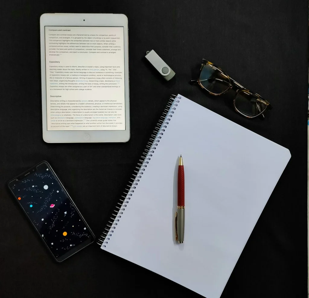 A woman deeply focused on writing morning journaling prompts in her notebook, enhancing her self-improvement journey.