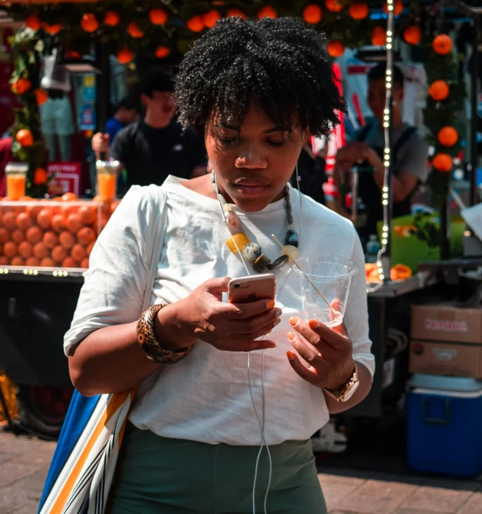 A woman engrossed in scrolling through TikTok, exploring the latest trends like MM to WW and Michelle Yeoh's Wicked.